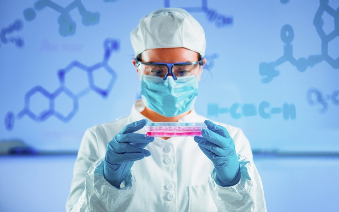 Life science researcher holding 24 well plate